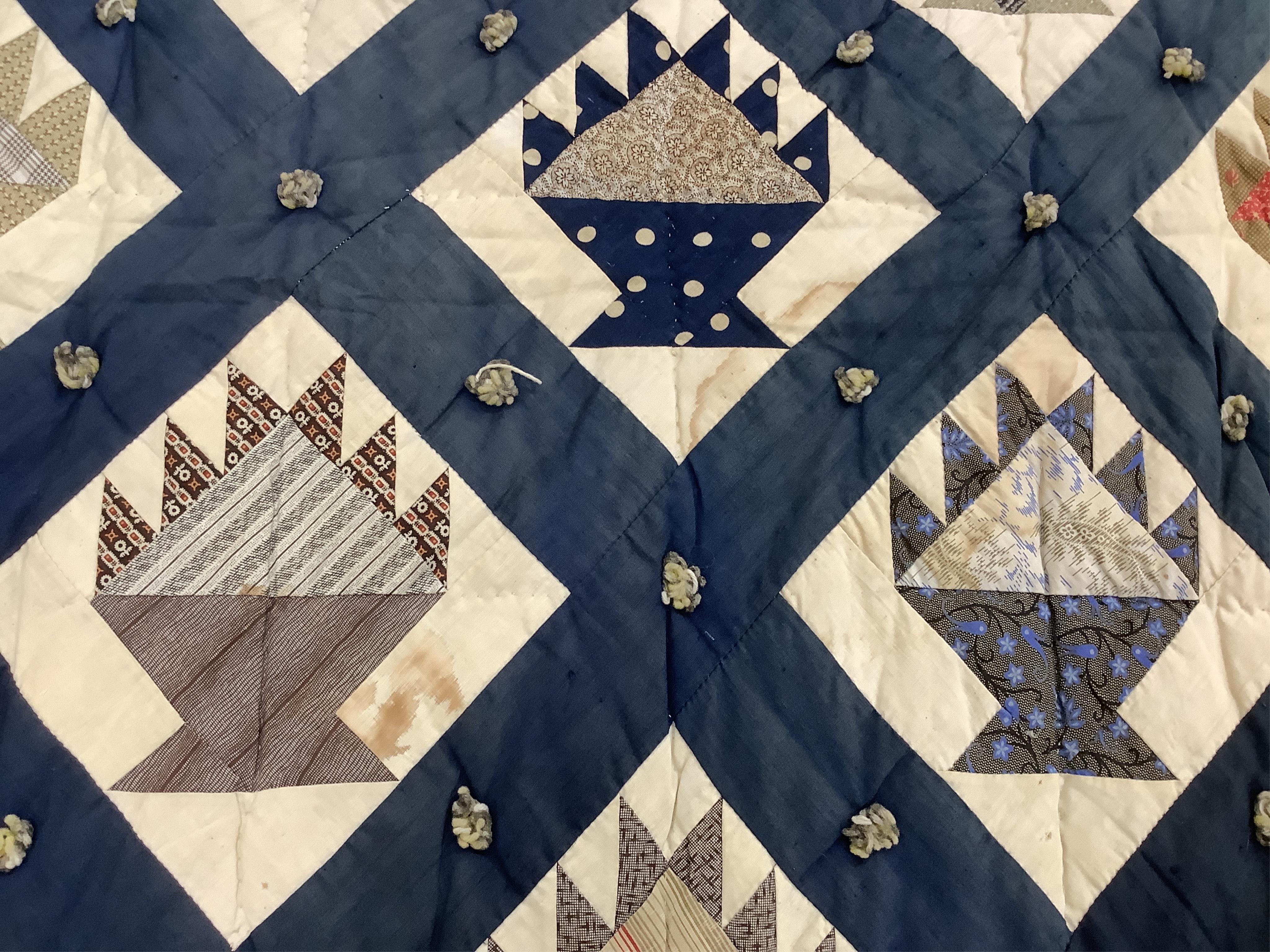 A bold handsome, American, Vermont 1865 (Civil War) ‘basket’ and lattice, hand quilted and piece tied bedcover, with an ornate floral backing. Worked with a plain navy cotton lattice border around central stylised printe